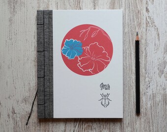 Notebook illustrated with red moon of flowers. Japanese binding.