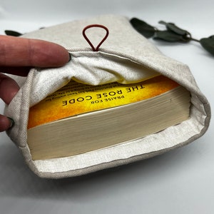 Inside of book sleeve with 300+ page paperback for size reference -tan book sleeve