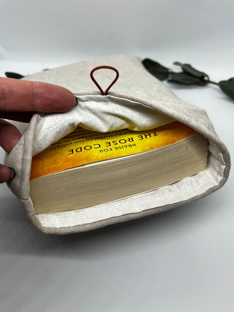 Inside of book sleeve with 300+ page paperback for size reference -tan book sleeve