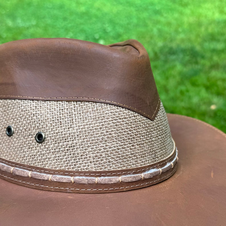 May include: A brown leather and woven straw hat with a wide brim.