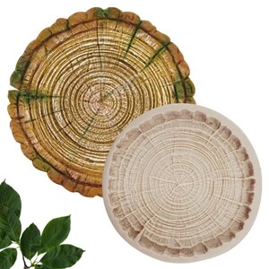 May include: A set of two round silicone molds for baking. The molds are shaped like tree rings with a brown and green color scheme. The molds are perfect for creating unique and decorative cakes, cookies, or other treats.