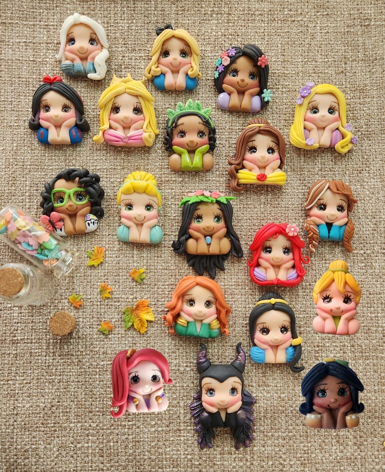 May include: A collection of 20 handmade polymer clay figurines of Disney princesses, each with a different hairstyle and outfit. The figurines are all smiling and have their hands on their chins.