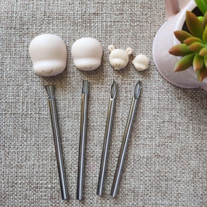 May include: Five metal sculpting tools with different shaped tips, and four silicone molds for making small figures. The molds are shaped like a bear, a small round shape, and two larger round shapes with facial features.