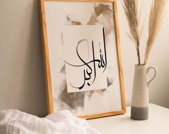 May include: A framed print with a white background and brown abstract brushstrokes. The print features black Arabic calligraphy that reads "Allah", which is the Arabic word for God.