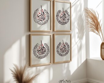 May include: Four framed art prints featuring Arabic calligraphy in black and red on a cream background. The prints are in light wood frames and are arranged in a square on a white wall. The bottom right corner of the wall has the text "artevs stories".