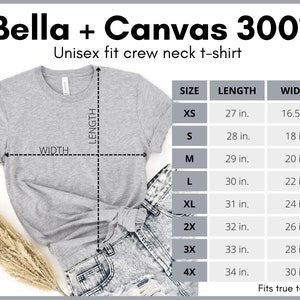 May include: A heather grey unisex fit crew neck t-shirt from Bella + Canvas 3001. The image includes a size chart with measurements in inches for sizes XS to 4X. The shirt is paired with denim jeans.