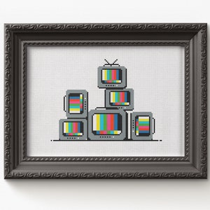 May include: A framed cross-stitch artwork depicting a stack of vintage televisions with static screen patterns in various colors.