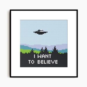 May include: A pixel art cross-stitch pattern featuring a UFO flying over a forest with the text "I WANT TO BELIEVE" underneath.