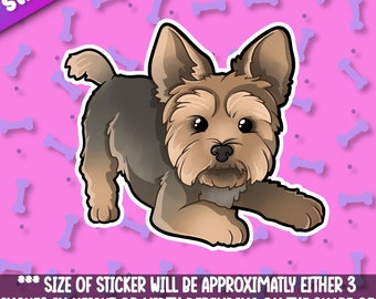May include: A cartoon sticker of a brown and black Yorkshire Terrier dog with a pink background. The sticker is approximately 3 inches in height or width.