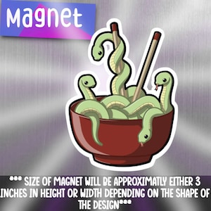 May include: A red bowl filled with green snakes and chopsticks. The snakes are curled up in the bowl, and the chopsticks are sticking out of the top. The bowl is on a silver background. The text "Magnet" is at the top of the image.