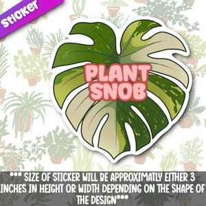 May include: A die-cut sticker featuring a split leaf design in shades of green and cream, with the text "PLANT SNOB" in pink bubble letters. The sticker is approximately 3 inches in height or width. The background shows a pattern of potted plants.