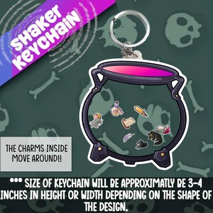 May include: A black cauldron keychain with a pink interior and a silver key ring. The cauldron is filled with small charms that move around inside. The keychain is approximately 3-4 inches in height or width.