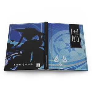 May include: A blue and white book with a silhouette of a person on the front cover. The book has the title "国崩" on the back cover.