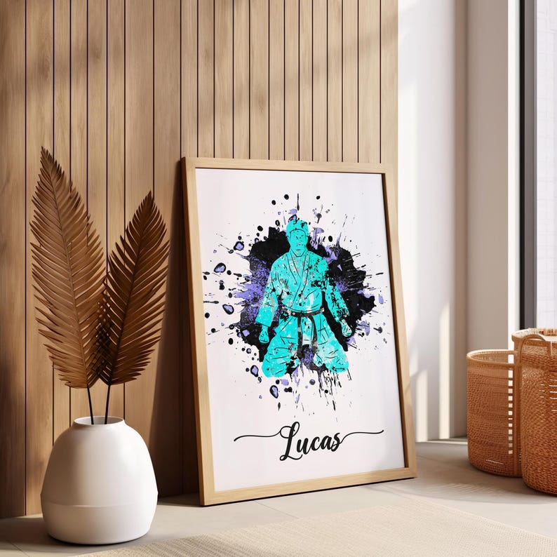 May include: A framed print with a blue silhouette of a person in a karate pose against a black and purple watercolor background. The name "Lucas" is written in cursive at the bottom of the print.