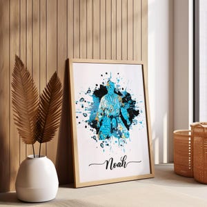 May include: A framed print with a blue and gold watercolor splash design featuring a person in a martial arts uniform. The name "Noah" is written in cursive at the bottom of the print.