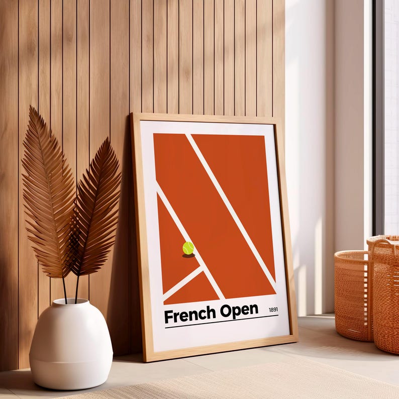 May include: A framed print of a tennis court with a single tennis ball on the red clay surface. The print has the text "French Open 1891" at the bottom.