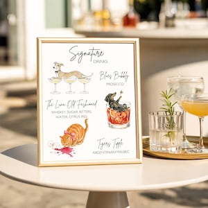 以下が含まれることがあります： Signature Drinksと題された額入りの看板で、動物とカクテルの水彩画が描かれています。Blues Bubbly Prosecco、ウィスキー、砂糖、ビターズ、水、柑橘類の皮を使ったThe Luna Old Fashioned、Tigers Tipple Argentinian Malbecが記載されています。