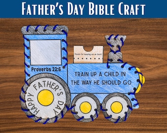 May include: A blue and gray train-shaped Father's Day Bible craft with the text "Father's Day Bible Craft." The train features the text "Train up a child in the way he should go" and "Proverbs 22:6."