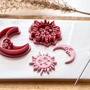 side view of sun and moon clay cutters to show sharp edge and stamp details.