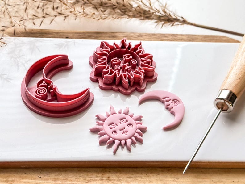 side view of sun and moon clay cutters to show sharp edge and stamp details.