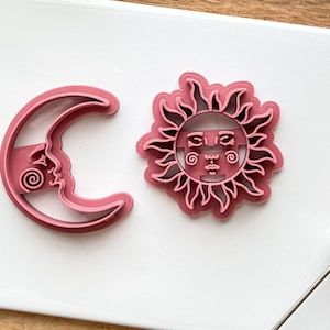 close up of celestial sun and crecent moon cutter set showing details.