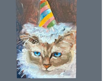 May include: A white cat with blue eyes wearing a colorful party hat with a blue top. The cat is looking directly at the viewer.
