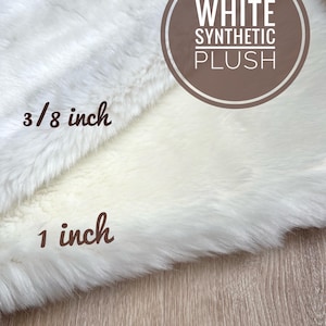 May include: White synthetic plush fabric in two different pile heights. The fabric is shown with a label that reads "WHITE SYNTHETIC PLUSH". The pile heights are labeled "3/8 inch" and "1 inch".