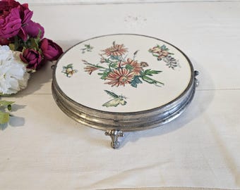 Antique earthenware and metal trivet