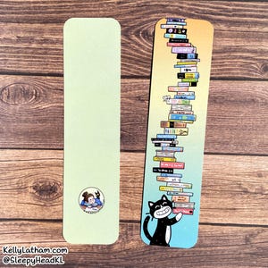 May include: Two bookmarks. One is pale green with a small illustration. The other has a gradient background and a stack of colorful books. A black cat with a white smile holds the books. Text at the bottom reads "KellyLatham.com @SleepyHeadKL".