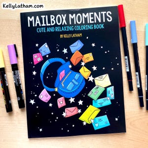 May include: A black coloring book titled "MAILBOX MOMENTS" with a blue backpack illustration and colorful envelopes. The book is accompanied by several colored markers in various colors, including red, blue, and purple.