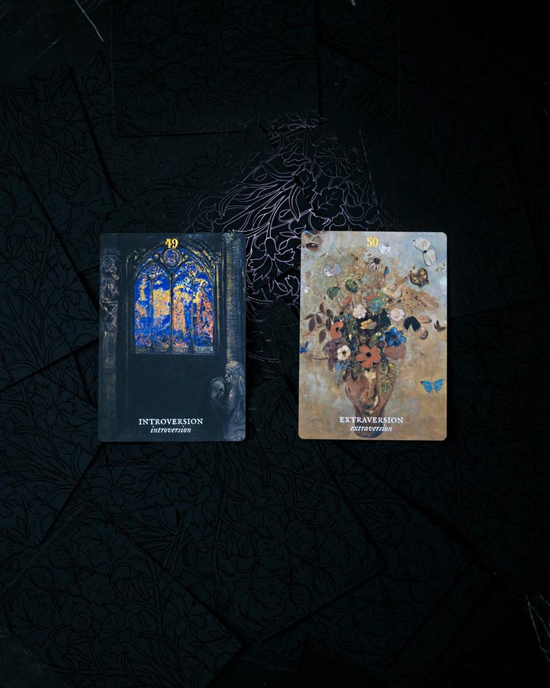 May include: Two tarot cards with dark backgrounds. One card features a stained-glass window with the word "Introversion" and the number 49. The other card shows a floral arrangement with butterflies and the word "Extraversion" and the number 50.