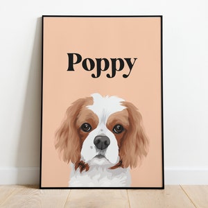 May include: A peach-colored poster with a black border features a cartoon illustration of a Cavalier King Charles Spaniel dog with brown and white fur. The dog's name, "Poppy", is printed in black at the top of the poster.