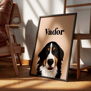 May include: A framed print of a Bernese Mountain Dog with the name "Vador" printed on a peach background.