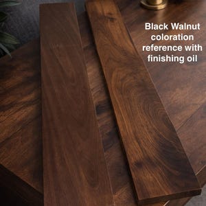 May include: Two rectangular black walnut wood boards with a smooth, oil-finished surface showing natural dark brown grain patterns. The text "Black Walnut coloration reference with finishing oil" is printed on the right side of the image.