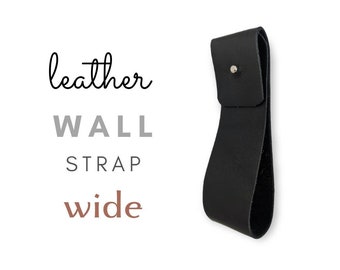 May include: Black leather wall strap with a wide loop and a silver rivet. The strap says "leather wall strap wide" in text.