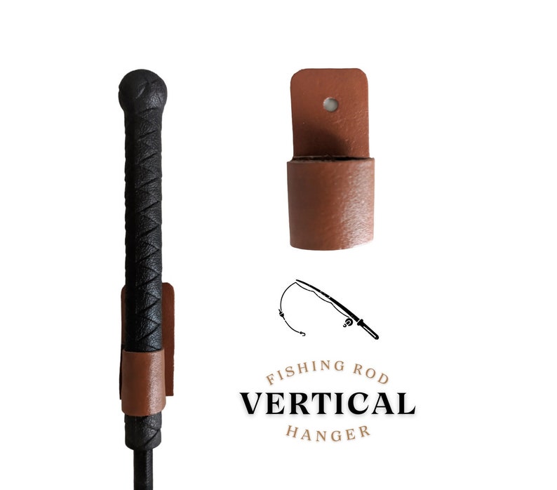 May include: A brown leather vertical fishing rod hanger with a black fishing rod in it. The hanger has a hole at the top for hanging on a wall. The text "Fishing Rod Vertical Hanger" is printed below the hanger.