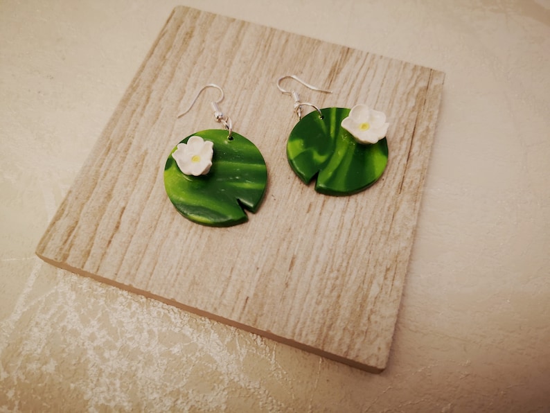 Handmade lillipad dangle earrings with a single white flower