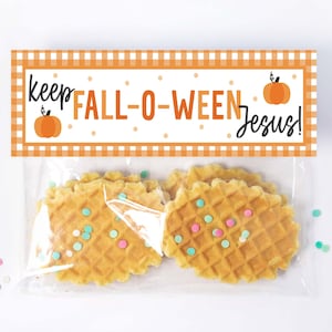 May include: A clear plastic bag with a white and orange checkered tag that says "keep FALL-O-WEEN Jesus!"  The bag contains waffle cookies with colorful sprinkles.