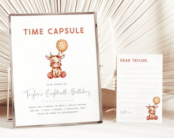 May include: A white card with the text "TIME CAPSULE" in red and brown. The card also has a cartoon illustration of a brown and white cow with a brown balloon. The text "TO BE OPENED ON Taylor's Eighteenth Birthday" is written in black. The card also has the text "PLEASE TAKE A MOMENT TO WRITE A SPECIAL MESSAGE FOR HIM - A WISH, A MEMORY, A PREDICTION, SOME ADVICE OR WORDS OF ENCOURAGEMENT".