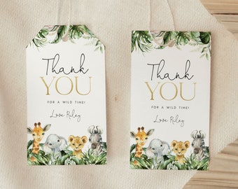 May include: Two white thank you tags with green and gold jungle animal illustrations. The text on the tags reads "Thank You" in gold lettering and "For a wild time!" in black lettering. The name "Love Riley" is written in black lettering below the text.