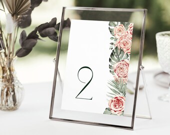 May include: A white table number card with the number "2" in dark green font. The card is decorated with a floral design featuring pink roses and green leaves.