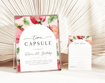 May include: A pink and green time capsule card with a strawberry pattern. The card says "Time Capsule" and "To be opened on Rosie's 18th Birthday". There is a separate card with the text "Dear Rosie" and lines for writing.