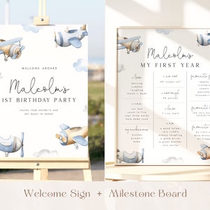 May include: A blue and white welcome sign and milestone board for a first birthday party. The sign features a watercolor illustration of a blue and brown airplane with clouds. The text on the sign reads "Welcome Aboard Malcolm's 1st Birthday Party". The milestone board features a watercolor illustration of a blue and brown airplane with clouds. The text on the board reads "Malcolm's My First Year". The board lists milestones such as "I love", "I can", "I weigh", "I have", "I am", "My nickname", "I am a", "Favorite foods", "Favorite book", "Favorite toys".