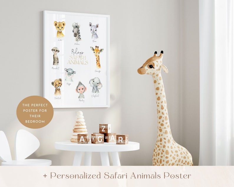 May include: A white framed poster with watercolor illustrations of safari animals, including a giraffe, zebra, cheetah, monkey, and elephant. The poster has the text "Rileys Safari Animals" in gold lettering. A stuffed giraffe toy stands next to the poster.