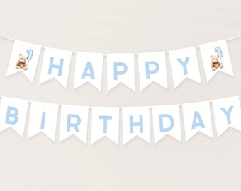 May include: A white banner with blue letters spelling "Happy Birthday" with a teddy bear holding a blue balloon on each end.
