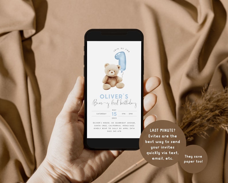 May include: A digital invitation for a baby's first birthday party. The invitation features a cartoon teddy bear holding a blue balloon shaped like the number one. The text on the invitation reads "Join us for Oliver's Bear-y First Birthday, Saturday, May 15, 2023, 1 PM - 3 PM".