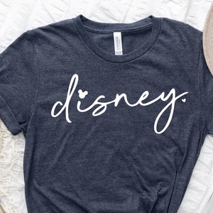 May include: A navy blue t-shirt with the word "disney" written in white cursive with a small heart on the "i".
