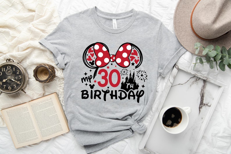 May include: Gray t-shirt with a red and white polka dot bow, a black castle, fireworks, and the text "my 30th birthday".