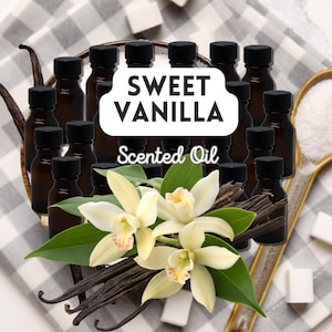 May include: Small brown bottles with black caps, labelled "Sweet Vanilla Scented Oil." The image features vanilla pods, white vanilla flowers, and sugar cubes, suggesting a sweet, aromatic product.