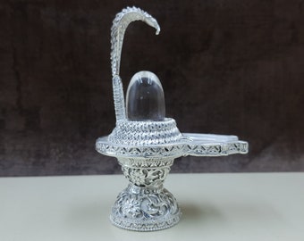 Crystal Lingam on yoni brass base with snake hood